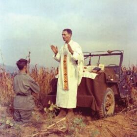 U.S. Army chaplain Father Emil Joseph Kapaun, who died May 23, 1951, in a North Korean prisoner of war camp, is pictured celebrating Mass from the hood of a jeep Oct. 7, 1950, in South Korea. He is a candidate for sainthood.  (CNS photo/courtesy U.S. Army medic Raymond Skeehan)